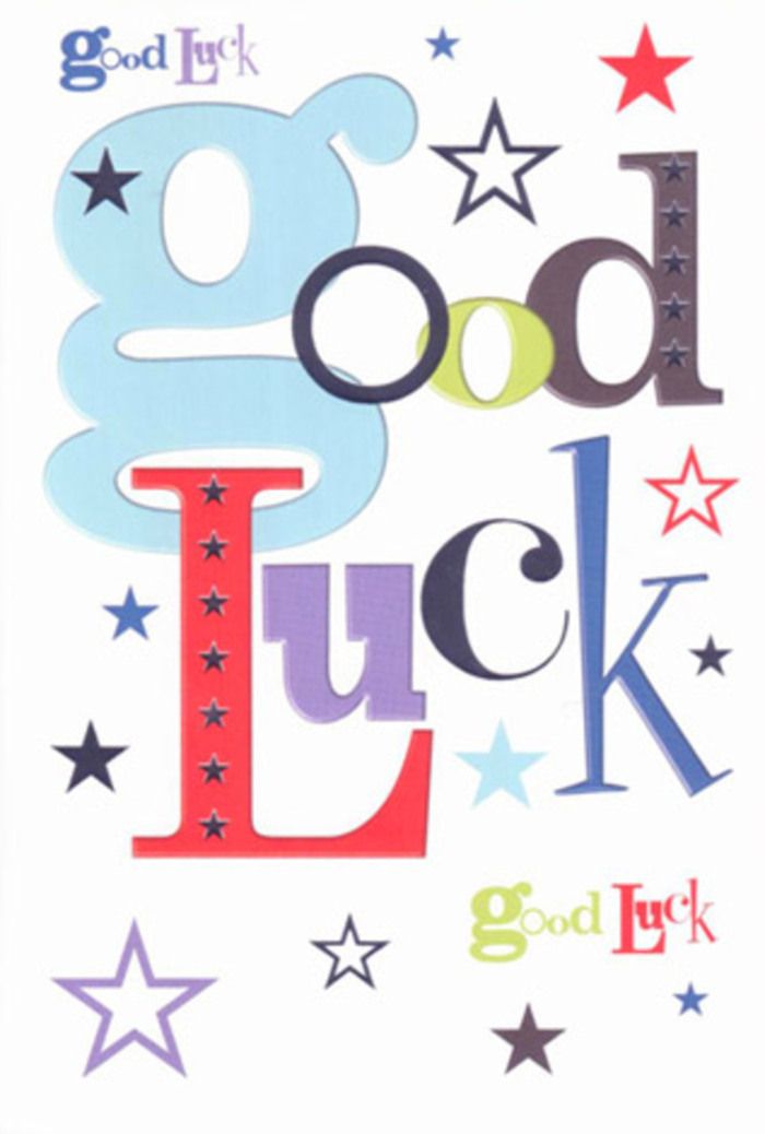 The photograph shows a vibrant, luck-themed greeting card laid flat, filling the frame with its easy, cheerful energy, the way a colourful market stall on Hildreth Street suddenly lifts your mood when you walk past. The card itself is built on a crisp white background, bright but gentle on the eye, offering plenty of breathing room around a central cluster of lively letters. These letters spell out Good Luck, yet they've been scattered just enough to feel informal and fun, reminiscent of hand-cut paper shapes arranged on a studio table before being glued in place. The most prominent shapes are the wide, pastel-blue letters, painted in a soft baby-blue hue that feels calm, optimistic, and inviting, like a clear morning sky over Tooting Bec. Around these anchor letters, thinner strokes in midnight black, joyful red, mossy green, and velvety purple appear, each one in its own distinct font. Some characters lean tall and narrow, others squat and rounded, giving the whole phrase a conversational, almost chattering quality, as though the word luck itself is cheering from the sidelines. All across and behind the typography, five-pointed stars of different sizes and tones are scattered with deliberate spontaneity. Deep navy and indigo stars give a sense of night-sky depth, while sky-blue, lavender, and soft lilac stars create a softer, dream-laden layer, with the occasional lemon-lime spark catching the eye like a fairy light glimpse through Balham's café windows after dark. The ink looks solid and saturated, the edges of each star and letter clean and precise, suggesting high-quality printing on smooth, slightly weighty cardstock. You can almost imagine the card's surface cool beneath your fingertips, the gentle resistance as you run a thumb over the printed shapes. The overall impression is of a modern, upbeat talisman of good wishes, perfect to tuck into a bouquet or hatbox arrangement being delivered across Balham to someone standing on the brink of a new adventure, from first homes to fresh careers.